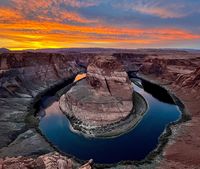 A large body of water surrounded by mountains photo – Free Horseshoe bend Image on Unsplash