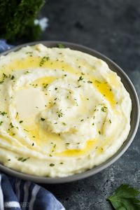 These easy Cream Cheese Mashed Potatoes are smooth, creamy and decadent! Perfectly seasoned with garlic and herbs -- once you make them this way you'll never go back! #potato #potatoes #recipe #dinner #recipes