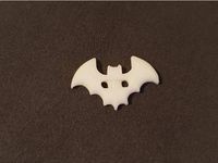 This button is shaped like a bat and has a size of ~30x18mm. It is designed for manually sewing it. It can easily be used with a 35mm button hole. Center Holes are 7mm apart. I use this as a button for a bat costume for halloween. I used some Glow-in-the-dark filament.