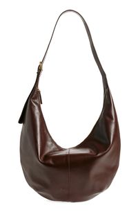 This slouchy bag is cool, modern and quietly luxe, and features a secure top zipper and interior pocket. The interior is roomy enough to hold your tablet, water bottle, phone, wallet and keys. Plus, it has an adjustable strap that can be worn crossbody or over the shoulder. Top zip closure Adjustable shoulder strap Interior wall pocket Lined Leather Imported