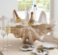 This Champagne ice bucket, decorative centerpiece, and catch-all bowl looks like a giant clam shell that measures over two feet wide. @potterybarn