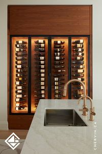 Rich walnut elements lend a timeless elegance to this space. With walnut horizontal grain slab fronts, angled walnut back panels, and metal framed glass doors in a sleek matte black finish with bullet hinges & integrated pulls, every detail exudes sophistication. Accommodating 136 wine bottles with black wine pegs, this wine rack is both functional and stunning. Strategic lighting adds the perfect touch, highlighting the beauty of every detail...#WineWall #WineRack #WineCellar #WineStorage