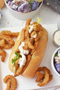 Classic New England Clam Strip Rolls at Home-A taste of summer with every bite, this classic New England Clam Strip Roll features a buttered roll, lettuce, and homemade tartar sauce for a delicious meal. Get the recipe for this clam strip roll and enjoy the fresh flavors. via @savvysavingcoup