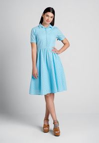 It doesn’t get more classic 1950’s-inspired than this baby blue fit-and-flare dress from Timeless London. Made from a lightweight, organic and sustainable cotton weave, fully-lined with a stunning overlay that boasts a broderie anglaise eyelet design, this gorgeous swing dress boasts button-up closure at the bodice with a hidden placket design, a smart point collar, short sleeves with a fold-over design at the cuff, and an ample flare skirt with handy side pockets!