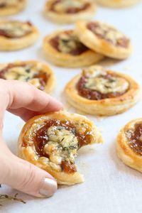 Caramelized onion and blue cheese tarts garnished with a drizzle of honey and sprinkled with fresh thyme