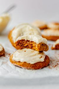 These pumpkin cookies are thick and cakey, with tons of pumpkin spice flavor, and a layer of cream cheese frosting. They're an easy cookie dough, made in one bowl, that you don't have to chill. You need basic cookie ingredients like flour, brown sugar, white sugar, eggs, and of course, pumpkin puree. They're ultra soft, light, and moist—perfect for fall, Thanksgiving, and Halloween. They can even be made gluten-free and dairy-free.