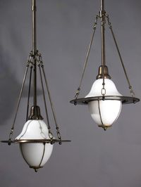 Circa 1915, these Celestial Opaline Leaded Glass Antique Lighting Pendant fixtures are a little more large scale for a bigger application. There are a set of three that would be very impressive in all of areas in your house not just a kitchen. Leaded glass bottom shade with opal whole shade on the top. There is an adjustment to let down the bottom shade and change the bulb. Have 3 @ $ 1040.00 each SOLD