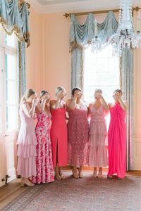 Bridesmaids in pink mismatched dresses get ready for first look with bride at Lowndes Grove wedding.