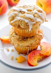 Soft and fluffy Fresh Peach Muffins are topped with a Creamy Cinnamon Vanilla Glaze! A delicious recipe sure to make you weak at the knees.