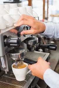 Barista making a cup of coffee at the coffee shop by Wavebreakmedia. Barista making a cup of coffee at the coffee shop#cup, #making, #Barista, #Wavebreakmedia