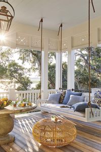 Swing Porch - The 2019 Southern Living Idea House - Beach house decor. Love the bedswing from the Original Charleston swing Company, Zuri decking - looks like hardwood, round table, blue and white accent pillows and copper gas lights - what a water view! Coastal living. #coastal #porch #porchideas #coastalliving #house #houseideas #homedecor #porchdecor #southernliving #homedecorideas #house #housedesign #beachhousedecor #islandstyle #dreamhouse #dreamhouseideas #housegoals