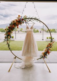 Circular Arch with Floral Arch Pieces in an Orange and Blue Color Palette. Utah Wedding Florist