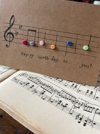 "Music design with buttons on brown Kraft card size 4\"x 6\" Inside is blank for your own message.  Sold individually.  Each card is hand made and one of a kind with slight variations.  Envelope included.  A 4x6 photo will fit inside the card and envelope. Available in black buttons or multi colored."