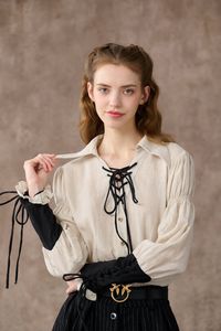 This shirt from linennaive takes inspiration from the bygone romance and whimsy of sailing. very inch exudes a carefree spirit It's cut from soft linen in a relaxed silhouette and has contrast sleeves to make it stand out. Elegant ruffle details add drama to this piece, making it effortless and romantic. Contrasting lace-up detailing at front - feel free to tie it in a bow for a playful feel. This shirt creates an effortlessly cool look without any styling on your end. Pull it on and enjoy your