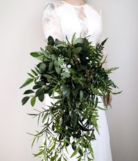 Please read all information below, but pay extra attention to our FAQs below which details the production time if you are planning an event and need the arrangement within a certain time frame! Description: This is a variation of our all greenery bouquet with draping cascading greenery. The Billie collection is an all greenery collection with pops of gypsophila and/or small wildflowers. This arrangement is made of all artificial stems. Approx. width of the bouquet is at least 17” with long drapi