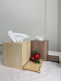 Elegant square tissue box with wooden cover.   Functional and decorative, the wooden tissue paper cover boasts modern elegance and looks good in any bedroom, kitchen, living room, or office. Or you can also use it in your bathroom for a decorative touch.