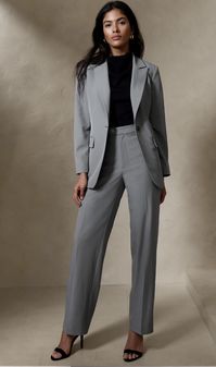 Grey tailored suit from Banana Republic. Suit consists of a blazer and matching high waisted, straight leg pants. "Womens fit". Color light grey heather