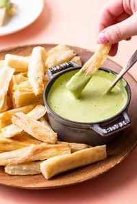 Healthy and delicious baked yuca fries with cilantro lime dipping sauce. A Cuban-inspired side dish or appetizer, and perfect alternative to French fries! thenewbaguette.com