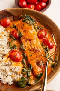 Roasted Red Pepper Salmon with delicious creamy sauce. Serve it with rice, pasta, or couscous for a delicious complete meal for weeknight dinners. This seemingly fancy dinner is perfect for special occasions and holidays too.