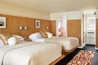 Original Pink Vintage Tubs and Knotty-Pine Walls Made The Cut In This 1950s Motel Reno