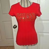 Guess Los Angeles Women Short Sleeve Tee Top Size S Short Sleeve Crew Neckline Rexi Crew Red Color Gold Metallic Rhinestone Crystal Logo On The Chest Small Thigh Fit Pullover Closer Every Season, Every Occasion % 100 Cotton 110 C Temperature Without Steam Wash Do Not Twist Pit To Pit 16" Should To Hem 23" Sleeve 6" Brand New With Tag Has Never Been Used Perfect Condition