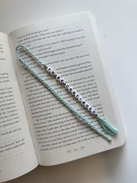 Introducing the Macramé Beaded Bookmark - the perfect blend of craftsmanship and functionality! This handmade macramé beaded bookmark adds a pop of fun to your reading routine. Slip it between the pages of your favorite book, journal, or planner. Each bookmark is handcrafted. The intricate macramé knotting technique, combined with carefully chosen beads, creates a one-of-a-kind piece of functional art. Beyond its aesthetic appeal, this bookmark is designed to withstand everyday use. The sturdy construction ensures it can endure the rigors of frequent page-turning while maintaining its charm. Searching for a thoughtful gift for the book lover in your life? Look no further! The macramé beaded bookmark makes a delightful present for birthdays, holidays, or just because. Personalize it with th