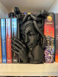 Product is 3D printed with PLA plastic and very light weight. The booknook is designed to go in between books and not useful as a bookend. If you have questions or concerns, please feel free to reach out. Add a touch of fantasy to your home decor with the Medusa Booknook. This cool medusa statue is perfect for any fantasy book lover and will make a great addition to your bookshelf. A must have for Percy Jackson fans. Color: Black Quantity: 1 per pack Material: Plastic Style: Fantasy Theme: Fanta