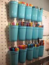 for the school room closet. Ballpark plastic cups become a wall of pen and marker storage. Two holes are punched into the back of the cups, then secured with zip ties through the cup and the pegboard.