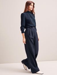 Style & Fit Notes We defy anyone not to love the grace of a high-waisted, wide-legged trouser. The Margot is cut from a mid-weight wool-blend with slight stretch to hold its shape. Elegant and on-trend, pair with a silk blouse or our contrast cuff Josie jumper for an effortlessly chic office outfit. For specific garment measurements please refer to size guide on product page. Model is 5ft 10in / 1,78m and wears a size UK10 Inside leg length for size UK10 measures 82cm Fits true to size, take you