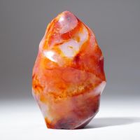 Top-quality Carnelian agate freeform from Madagascar. This beautiful piece has rich golden-yellow to red-orange color and is hand polished to a smooth, highly reflective surface. Carnelian agate is a powerful Sacral Chakra Stone. Carnelian increases personal power and physical energy, gives courage, and boosts creativity and compassion. Mentally, Carnelian focuses analytical capabilities, and aids meditation by allowing deeper concentration and keeping out interrupting thoughts. It is useful in