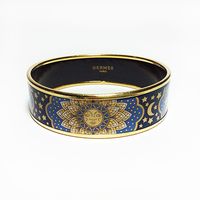 - Gold-plated brass trim- Sun, moon, and stars printed enamel- Blue, navy, and gold colors- Rare!!!Measurements:- Size 65- Diameter 2.6- Width .75Condition: Excellent