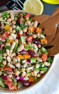 Mediterranean Bean Salad packs chickpeas, white beans, your favorite Mediterranean vegetables and feta cheese into one healthy salad and is topped with a light lemony dressing. This works perfectly as a side dish to a meal or even as lunch with pita bread and hummus. // A Cedar Spoon #salad #beans #Mediterraneandiet #Mediterraneanfood #fetacheese #cheese #healthy #recipe #cleaneating #vegetarian #vegetables #olives #kalamataolives #lunch #easylunch #whitebeans #lemon #homemadedressing #easysalad