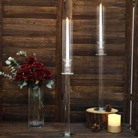 PRICES MAY VARY. Quantity: 2 Candle Holders Material: Glass Color: Clear Style: Crystal Candlestick w/ Tall Glass Shades Total Height: 25.75" Base Height: 17" Tube Height: 11.75" Tube Diameter: 2.25" Holder Diameter: 2.2" Holder Depth: 1.6" Holder Base Diameter: 3.75" Assembly Required: Yes, easy to assemble. Sturdy round base, not easy to shake and fall over. HIGH QUALITY: These candle holders are made from high-quality premium material. To make things swankier, we have designed it on the master of luster. This elegantly shimmering piece comprises shiny material crafted with the utmost perfection. CAPTURES ATTENTION: These candle holders will add imperial shimmer and surreal sophistication to your events. Inspire your guests and invitees with these beautiful candle holders. The glimmering