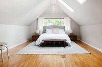 Skylights fill the master bedroom with light. At night, the beautiful chandelier adds a warm glow to the space. It's one of Amy's favorite things in her home.