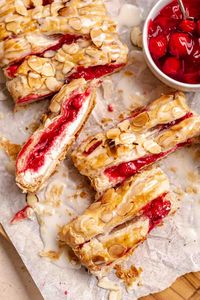 This Cream Cheese Cherry Danish with Puff Pastry is a surprisingly simple and impressive homemade treat! It has golden brown, flaky puff pastry dough filled with an almond-flavored sweet cream cheese mixture and cherry filling, and the sweet pastry gets topped with sliced almonds and almond glaze.