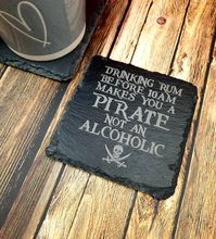 Engraved Slate Coaster - Drinking Rum makes you a pirate not an Alcoholic  This beautiful Laser Engraved slate coasters come with cushion support underneath so won't scratch your surfaces! Order individually or as a set! decorative Natural Slate Coaster   measure 10cm by 10cm made and engraved From Thick Slate These Slate Coasters Make a perfect addition to any Kitchen, Bar, Man Cave, Woman Cave Conservatory, and would look lovely in any Home Decor.  Perfect for Christmas Presents, Wedding Prese