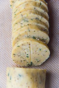 Recipe process for making thyme and cheddar cheese cookies - Slice and bake cheese cookie dough log sliced thin to make cookies.