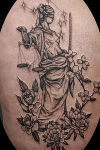 Black stippling style scales of justice and libra constellation with floral foreground