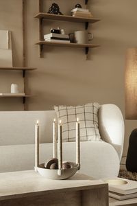 Bowl Candle Holder - Rico Sofa - Calm Cushion - Sector Shelves. The Bowl Candle Holder is at once a decorative and multifunctional piece. Its unglazed, grainy ceramic contributes to a raw, natural expression. Let the candle holder make a simple yet elegant impression with a set of lighted candles. You can use the centre of the bowl to store your favourite decorative items of the season.