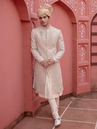 If you exude an elegant and sophisticated personality, then this timeless off-white silk sherwani is the perfect choice for you. Adorned with exquisite embroidery, delicate beads, and intricate cutdana work, this sherwani is embellished to perfection, adding a touch of opulence to your ensemble.