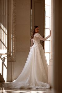 This wedding dress is a vision of pure luxury, ensuring the bride feels like a true princess on her special day. The gown is tailored in allover Chantilly lace with transparent sequins, while the highlight of this enchanting dress is its opulent embellishment with 3D floral appliques, lavishly adorned with delicate beads. #OliverMartino #pariscollection #weddinginspiration #weddinggowns #weddingdress #weddingcollection2024 #Chantillylace #princessgown #3dfloralappliques #dresswithbeading