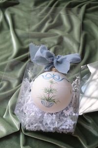 This charming ornament is perfect for adorning your tree or gifting to someone special. Each one is a work of art, meticulously crafted to celebrate the beauty of the Christmas season.  The 3" ceramic sphere is hand-painted, sealed with a matte varnish, then finished with a raw-edge chiffon ribbon.  Sold individually; visit my shop Elizabeth Alice Studio for other designs.