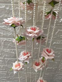 Product Item: Rose Wall Hanging  Material - Artificial Rose Flower, Pearl, Thread Color- As Show The Picture  Size - 6 feet Approx. Transform your event into a blooming paradise with our Hanging Flower Curtain Floral Backdrop! This enchanting backdrop is perfect for any theme, creating a mesmerizing wall of flowers that will leave your guests in awe. Hang it on walls or doorways to instantly elevate the ambiance. The delicate Rose flower garlands add a touch of elegance and are perfect for decor