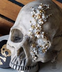 This easy how-to will turn a simple Halloween skull prop from meh to marvelous with some simple aging paint techniques, jewels, and beads.