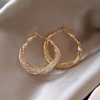 Twisted hoop earrings with a unique design Inheriting the bold style of traditional hoop earrings, these crystal twisted hoop earrings have a more stylish and unique design. A diamond belt wrapped in crossed gold threads, just like the Milky Way spread out on the night sky, bright and charming. The gold hoop earrings are about 3.1cm (1.22 inches) in diameter, and when worn, the end of these diamond hoop earrings will fall to your lower jaw. These bold and sparkly hoop earrings are perfect for sh