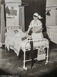 More than a year into the war in 1940, another photograph shows a nurse at St Bartholomews Hospital in West Smithfield, laying out gifts at the end of her patient's bed ready for them to wake on Christmas morning