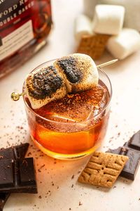 Who doesn't love a sweet gooey s'more around a campfire in the summer or fall? Well, this s'more old fashioned takes all those flavors and turns them into a delicious bourbon cocktail! It starts with a graham cracker-flavored simple syrup, then it is a good sweet bourbon, Angostura, and chocolate bitters, and finished with a toasted marshmallow.