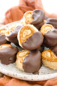 Buckeye treats is made with Peanut Butter and dipped in Chocolate. This Easy Buckeye Recipe has added Pretzels and the sweet and salty combo is amazing! This recipe is easily made by melting chocolate using your Instant Pot or pressure cooker. Curb your appetite with this sweet and salty snack! #devourdinner #easydessert #dessert #snack #easysnack #buckeye #buckeyerecipe #easybuckeyerecipe #chocolate #Peanutbutter #Reeses #chocolatepeanutbutter #recipe #recipes #food #foodie #yum #yummy