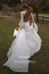 Pierlot is one of our lace wedding dress masterpieces! She is mesmerising with a base of stretch Chantilly lace, detailed embroidery panels and hand appliqué motifs. Pierlot is a fit and flare artistic creation, with stretchy sheer long sleeves and stunning open back.