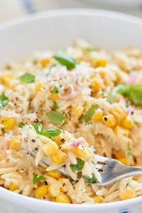 Creamy Corn and Basil Orzotto. It’s creamy, cheesy, and flecked with summer sweetness in the form of corn kernels and chopped basil. It’s also incredibly easy to throw together. You can get a satisfying vegetarian dinner on the table in under 30 minutes.